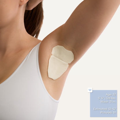 A close-up of a woman's underarm wearing an adhesive underarm patch, with a white tank top visible. A small blue text box with body measurements appears in the lower right corner.