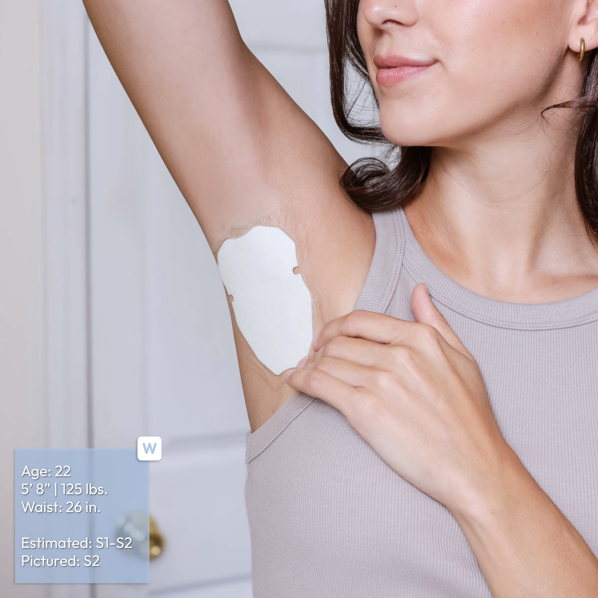 A woman wearing a light gray ribbed tank top shows an underarm patch application on her armpit. The image includes a size reference label in the bottom-left corner with text reading: Age: 22, 5'8" 125 pounds, Waist: 26 inches, Estimated S1-S2, Pictured S2.