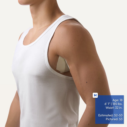 A close-up of a man wearing a white ribbed tank top, showing the side and underarm area showing an underarm adhesive patch applied to his armpit with his arm down. A blue text box in the lower right lists estimated body measurements and the pictured size.