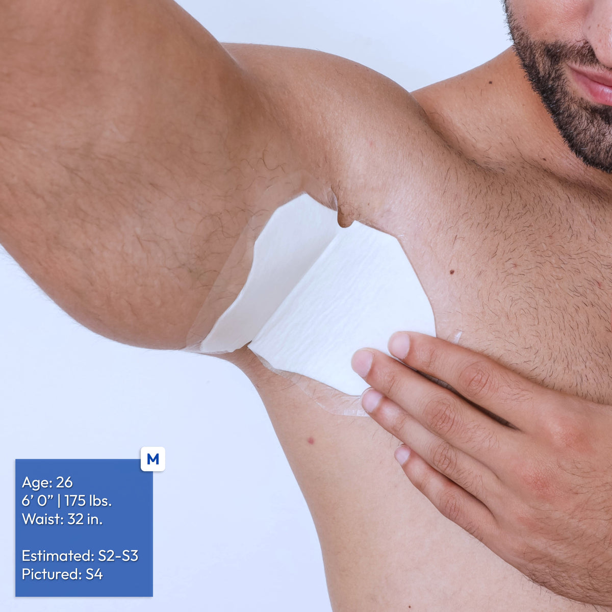 A close-up of a man's underarm area showing a white adhesive patch applied. A blue size/age overlay appears in the lower left corner.